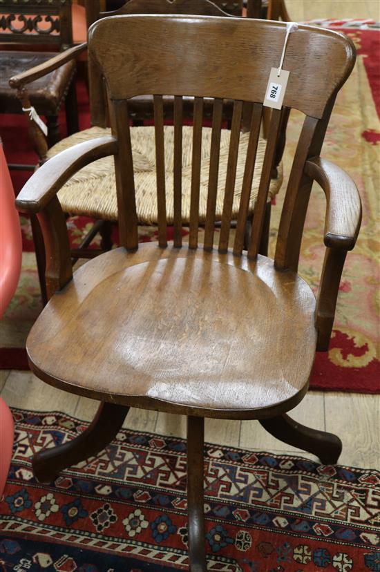 An early 20th century oak swivel desk chair